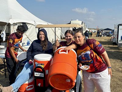 The Arizona Conference kitchen crew, working long hours, carries water to the kitchen.